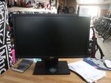 a computer monitor sitting on a desk in a bike shop