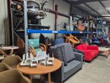 many chairs and tables in a warehouse with a lot of furniture