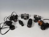 many different types of cameras sitting on a table