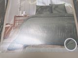 the box of the bed is packed with the comforter and pillows