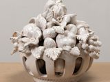 a white vase with a bunch of flowers inside of it