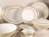 many different types of plates and bowls on the table