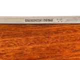 a close up of a piece of wood with a knife on it