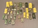 a lot of toy army vehicles that are on a table