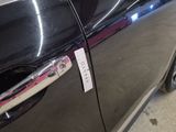 a close up of a car door handle with a sticker on it