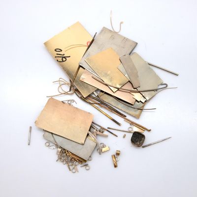 a pile of metal scraps on a white surface