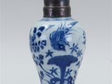 a blue and white vase with a bird on it