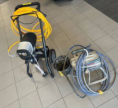 a small machine that is sitting on the floor next to some hoses