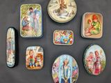 several tins of different types of tins on a black surface