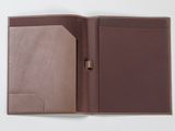 an open brown leather folder with a pen on top of it