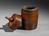 an old wooden jar with a lid sitting on a table