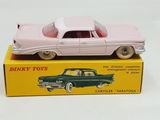 a pink toy car sitting on top of a yellow box