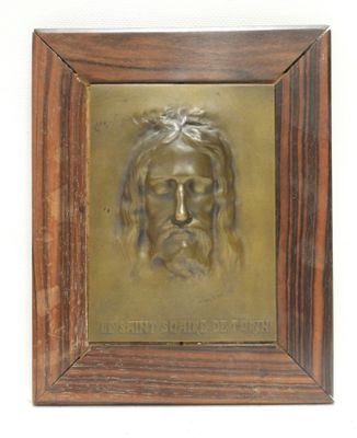 painting of a man ' s face in a wooden frame