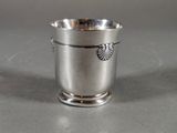 a silver cup that is sitting on a table