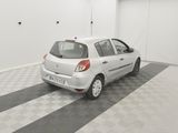 a picture of a small white car parked in a garage