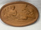 a plaque with a picture of a woman and two children