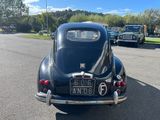 a black car that is parked on the side of the road