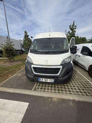 a white van parked in a parking lot next to a white van