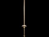 an old fashioned lamp on a black surface with a black background