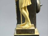 a gold statue of a man holding a staff