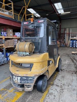 a yellow forklift truck parked in a warehouse