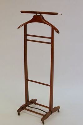 a wooden coat rack with a coat hanger on it
