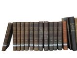 many books that are lined up on a shelf