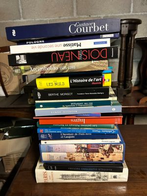 many books stacked on top of each other on a table