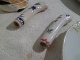 two pieces of porcelain on the table next to a plate