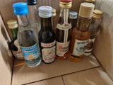 many bottles of alcohol sitting in a box on the floor