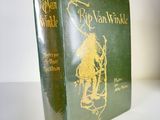 the book is green and gold with a picture of a man riding on a horse