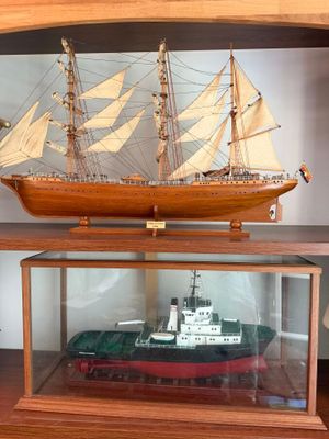 a model of a ship in a case on a table