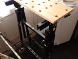 a workbench that is being built in the corner of a room