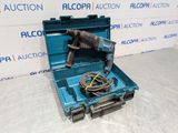 an open tool box with a drill and a cord in it