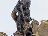 a statue of a man on a boat with a spear