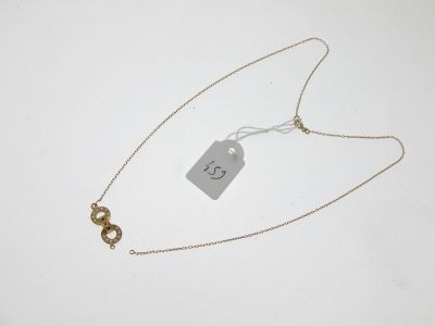 a close up of a necklace with a tag attached to it