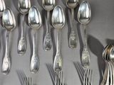 a lot of silver spoons and forks on the table