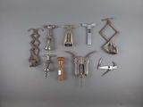 many different types of wine openers on the wall