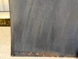 a black metal box sitting on the sidewalk