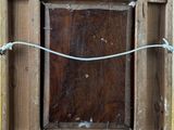 a picture of a wooden frame with a rope on it