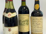 trois bouteilles de vin sont alignées sur une surface blanche