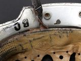 a close up of a baseball glove with a hole in it