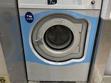 an image of a washing machine in a public bathroom