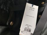 a black jacket with a fur collar and a tag on it