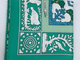 a green napkin with a picture of animals on it on a plate