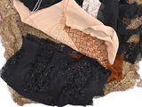 a pile of assorted lingersuits on a bed
