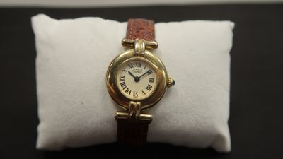 an image of a gold wrist watch with roman numerals on it