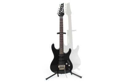 black electric guitar on stand against white background with shadow