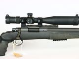 a close up of a rifle with a scope on a white background