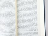 an open book on a table with a pen in it
